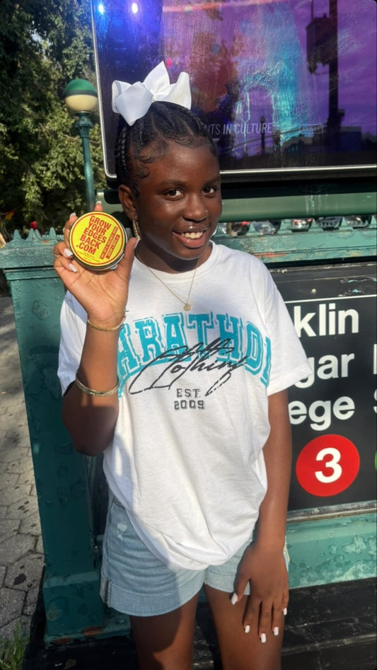 Customer outdoors in humid weather holding a jar of Grow Your Edges Back Edge Control