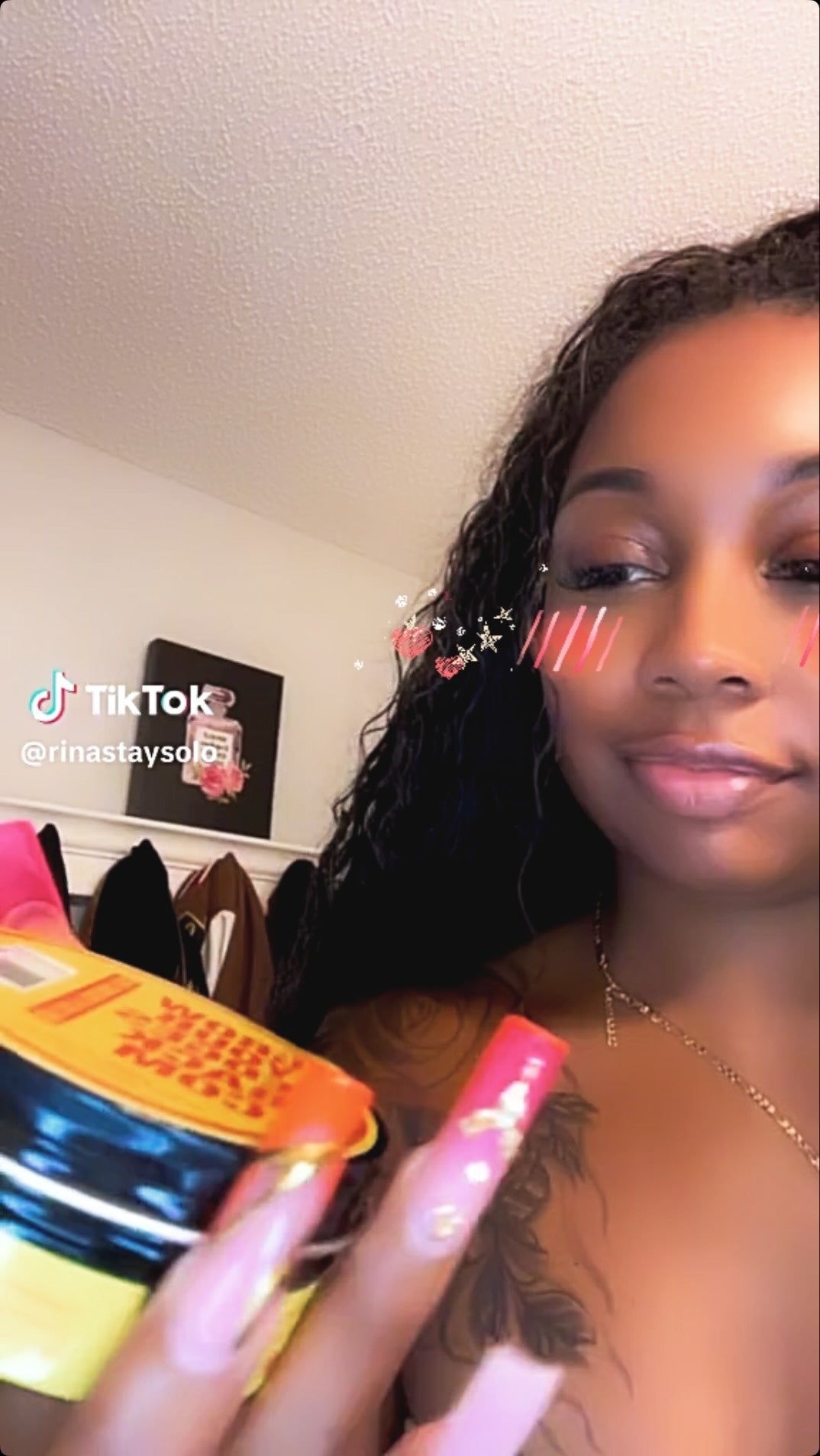 Latina customer holding Grow Your Edges Back products at her styling station