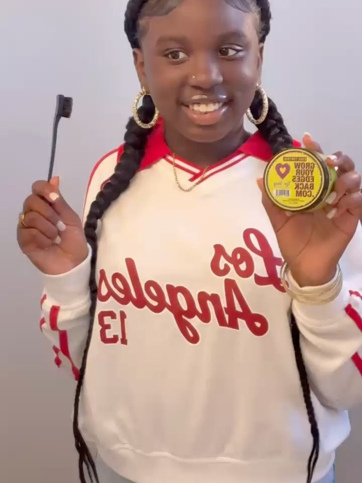 Smiling customer with smoothly laid baby hairs holding a jar of edge control