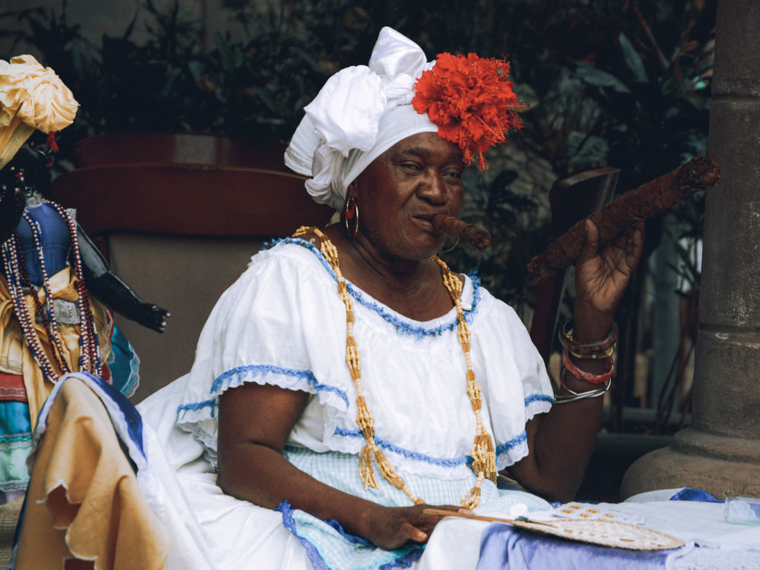 Afro-Cuban woman in traditional dress smoking a cigar, Havana, Cuba - Pexels photo by Mehmet Turgut Kirkgoz