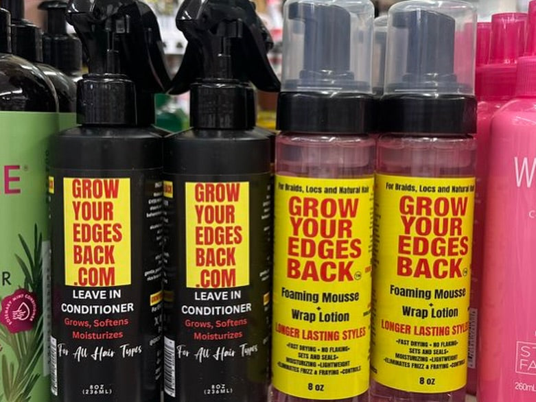 Leave-in conditioner and foaming mousse bottles on a retail shelf